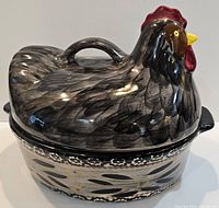 Side view of covered casserole showing full hen shape lid and patterned bowl