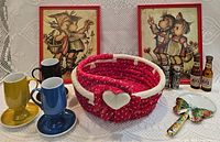Overall lot showing prints, cups with saucers, basket, shakers, mini bottles, magnifier