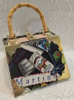 Front view showing martini collage, bamboo handle, gold-tone hardware