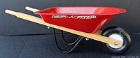 Left side view showing Radio Flyer logo, handles, wheel, frame