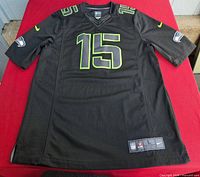 Front view of black Seahawks jersey showing number 15