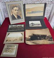 All seven mounted photographs arranged on table