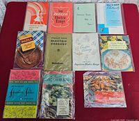 Group shot of all 11 vintage recipe pamphlets on red background