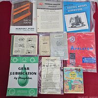 Overall view of all ten booklets and pamphlets in protective sleeves