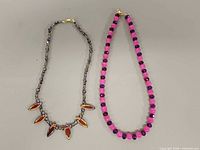 Two necklaces side by side showing overall design and clasp ends