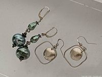Front view both earring pairs showing design and condition
