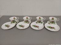 Full view of four cup and snack plate sets displayed