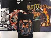 All five t-shirts laid out showing front graphics