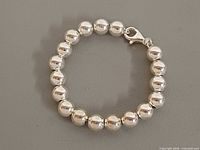 Full view of sterling silver bead bracelet closed, showing beads and clasp