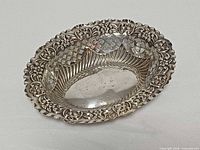 Oblique view showing ornate rim and interior repoussé decoration