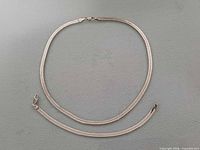 Necklace and bracelet laid flat to show full length and clasps