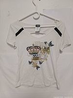 Front view showing graphic, sequined shoulders, neckline