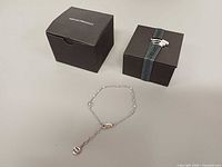 Bracelet laid out with two Emporio Armani boxes
