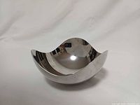 Oblique front view showing organic wavy rim and reflective surface