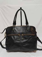 Front view showing overall design, handles, strap, pockets