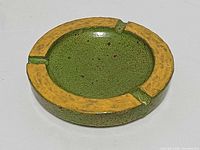 Top view showing green bowl, yellow rim, three rests