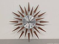 Front view showing full sunburst clock with wood spikes