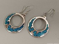 Front view of both earrings showing turquoise inlay and open hoop design