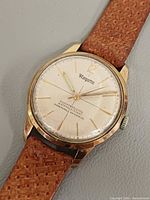 Front view showing dial, hands, indices, case and strap texture