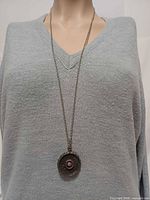 Necklace worn on mannequin showing pendant drop and chain length