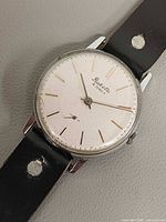 Front view of Reketa watch showing dial, hands, and strap condition