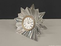 Front angled view showing starburst crystal form and clock face