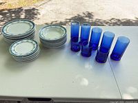 Entire lot showing stacks of plates, bowls and glasses