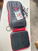 Full view of massage seat cushion with seat pad, remote and power cord visible