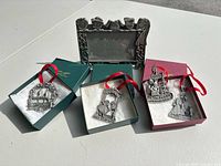 Overall lot showing three boxed ornaments, one additional ornament and the pewter photo frame