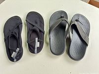 Both pairs: Skechers flip-flops and FitKicks slip-ons side by side