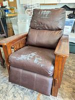 Front view of brown faux leather Mission style recliner showing peeling upholstery and wood frame details