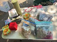 Overview of assorted gift boxes, bags, filler and ribbons on table