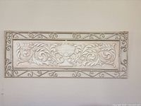 full front view of ornate metal and plaster wall panel