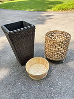 Three planters/baskets of varying sizes and materials