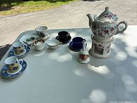 Group shot of entire mismatched tea set displayed on table