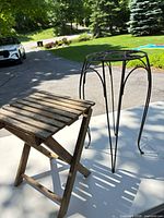 wood stool and metal plant stand together outdoors