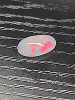 Top view of oval opal showing play-of-color