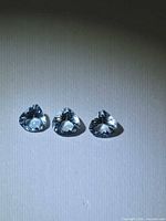Front view of three pear-cut aquamarines