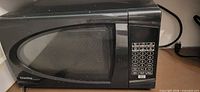 Front view of Danby microwave showing brand logo, door, and control panel