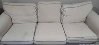 Front view showing entire sofa, all cushions, discoloration on left seat