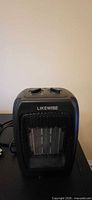 Front view of Likewise space heater showing grille and logo