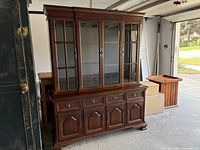 Front view showing entire two-piece hutch with glass display top and storage base