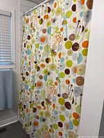 Full view of patterned shower curtain hanging