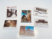 Three postcard sets closed and partially open showing covers and sample cards