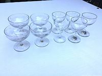 eight of the ten etched coupes arranged on table