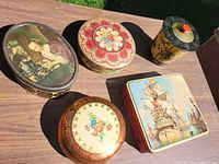 Top view showing five tins and their designs