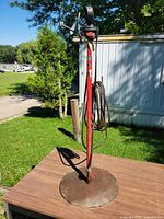 Full view of pole light showing socket, cord and weighted base