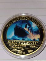 Obverse of gold-tone Titanic token showing enameled image and text
