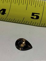 Gemstone beside ruler showing size between 4 and 5 inch marks