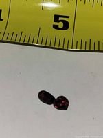 Heart and oval garnet gemstones with tape measure for scale